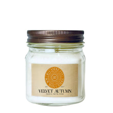 Load image into Gallery viewer, 
A velvet autumn scented wax candle in a clear glass 8 oz mason jar with a dark brown metal lid and a tan paper label. The label features a circular orange logo for JD CANDLE CO. SOY WAX CANDLE
