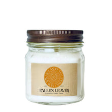 Load image into Gallery viewer, A fallen leaves scented wax candle in a clear glass 8 oz mason jar with a dark brown metal lid and a tan paper label. The label features a circular orange logo for JD CANDLE CO. SOY WAX CANDLE
