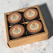 Load image into Gallery viewer, JD Candle Co. 4-pack autumn soy wax candle gift set featuring Apple Harvest, Brown Sugar Fig, Cinnamon Vanilla, and Pumpkin Souffle scents in 4 oz jelly jars and a brown lid, packaged in a brown cardboard box on a gray back ground. 