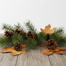 Load image into Gallery viewer, A decorative autumn pine garland with green pine branches, brown pinecones, and orange maple leaves arranged on a light wood surface against a white background.
