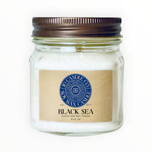 Load image into Gallery viewer, JD Candle Co. Black Sea soy wax candle in a clear glass jar with a rustic metal lid. Scent notes: ozone, sea salt, powder.