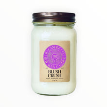 Load image into Gallery viewer, JD Candle Co. Blush Crush 16 oz jar candle with a bronze lid. Creamy white wax with a kraft paper label featuring "Blush Crush" scent notes of peach, hydrangea, and vanilla.