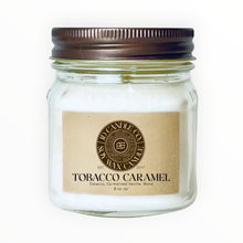Load image into Gallery viewer, JD Candle Co. Tobacco Caramel scented candle in an 8 oz glass jar with a rustic brown lid. Features a warm, woody, and sweet aroma.