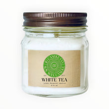 Load image into Gallery viewer, JD Candle Co. white tea scented soy wax candle in an 8 oz glass jar with a rustic brown lid. Notes of lemon, bergamot, and jasmine.